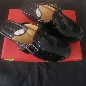 Nurture studded patent clogs